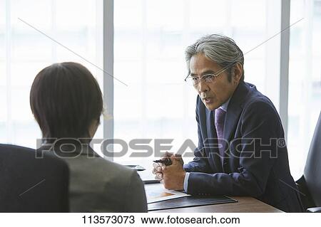 Japanese businesspeople in a meeting View Large Photo Image Stock Image - Japanese businesspeople in a meeting. Fotosearch