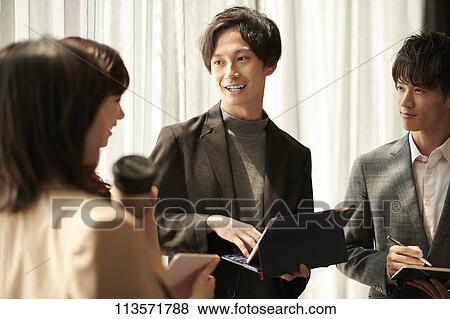 Stock Photo - Japanese businesspeople in a meeting. Fotosearch