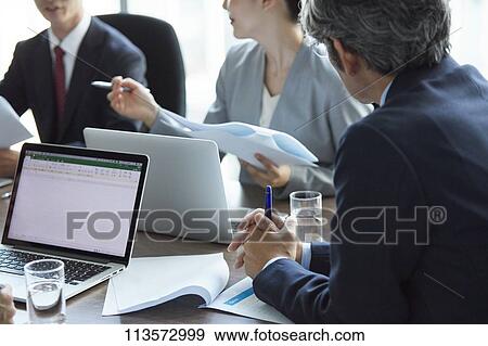 Japanese businesspeople in a meeting View Large Photo Image Stock Photo - Japanese businesspeople in a meeting. Fotosearch