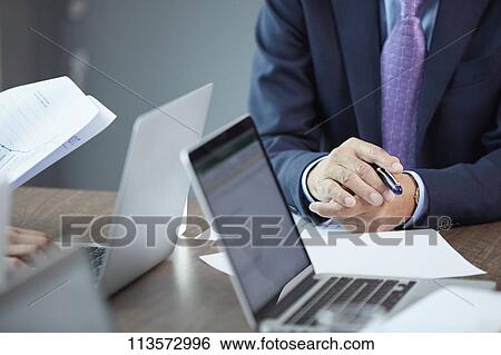 Stock Photograph - Japanese businesspeople in a meeting. Fotosearch