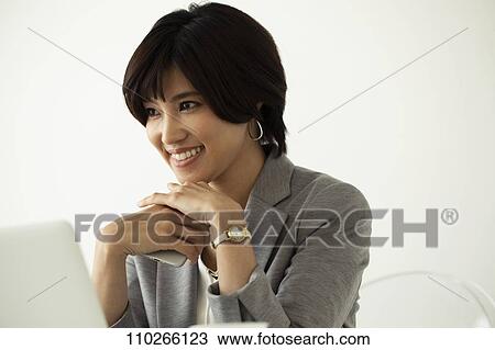 Stock Image - Japanese businesswoman in the office. Fotosearch