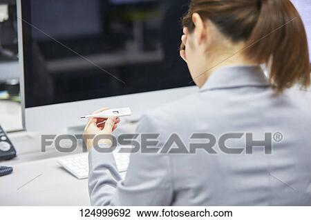 Stock Image - Japanese businesswoman in the office. Fotosearch