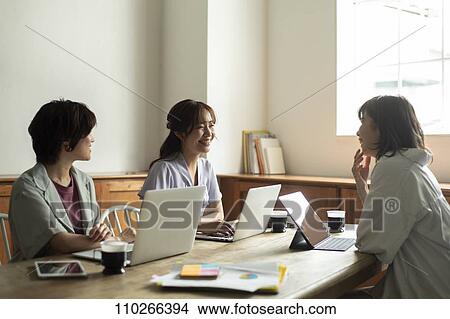 Picture - Japanese businesswomen in the office. Fotosearch