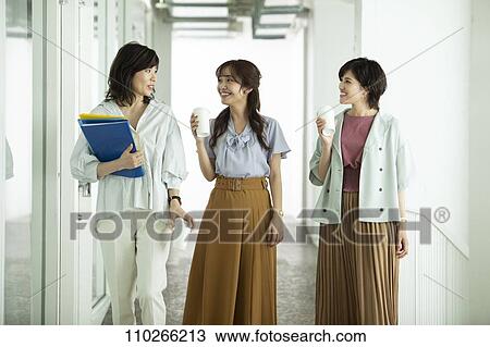 Stock Image - Japanese businesswomen in the office. Fotosearch
