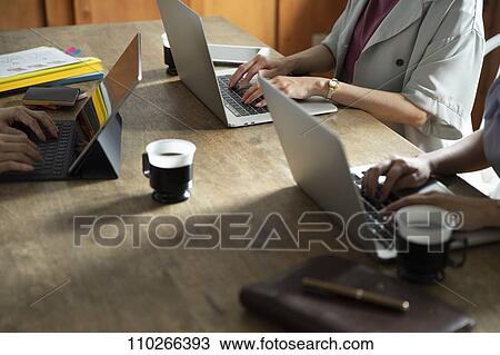 Stock Image - Japanese businesswomen in the office. Fotosearch