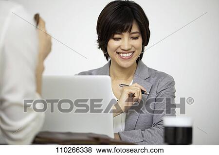 Stock Photo - Japanese businesswomen in the office. Fotosearch