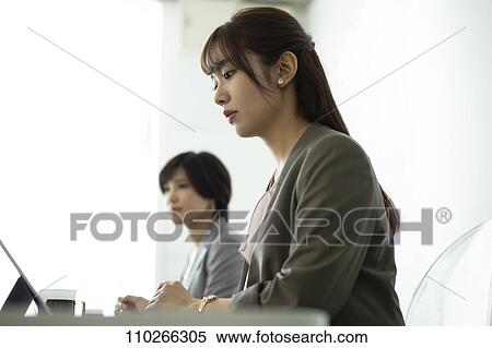 Stock Photography - Japanese businesswomen in the office. Fotosearch