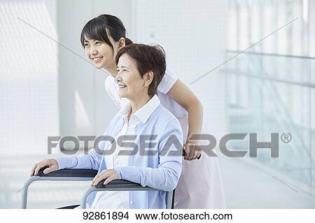 Japanese caretaker helping senior patient View Large Photo Image Picture - Japanese caretaker helping senior patient. Fotosearch