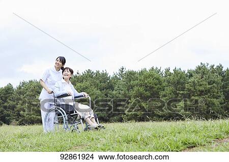 Japanese caretaker helping senior patient View Large Photo Image Picture - Japanese caretaker helping senior patient. Fotosearch