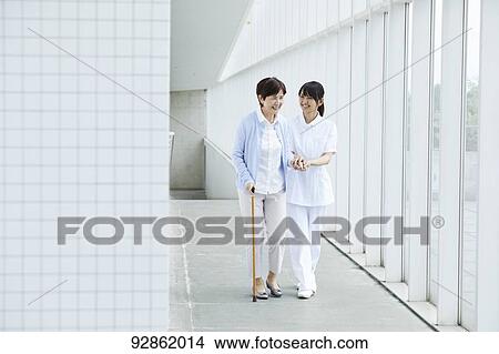 Japanese caretaker helping senior patient View Large Photo Image Picture - Japanese caretaker helping senior patient. Fotosearch