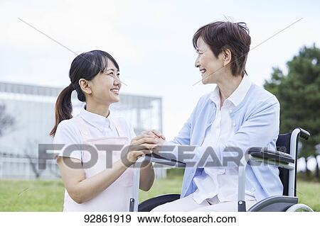 Japanese caretaker helping senior patient View Large Photo Image Stock Photo - Japanese caretaker helping senior patient. Fotosearch