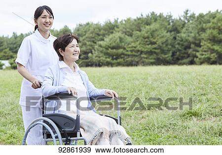 Japanese caretaker helping senior patient View Large Photo Image Stock Photo - Japanese caretaker helping senior patient. Fotosearch