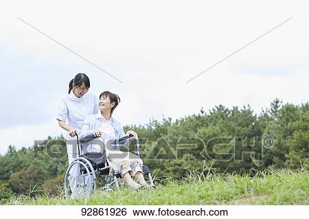 Japanese caretaker helping senior patient View Large Photo Image Stock Photograph - Japanese caretaker helping senior patient. Fotosearch