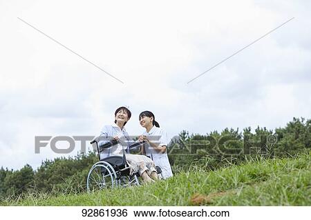 Japanese caretaker helping senior patient View Large Photo Image Stock Photograph - Japanese caretaker helping senior patient. Fotosearch