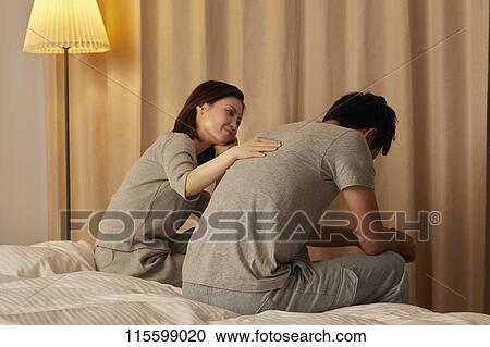 Stock Image - Japanese couple in bed. Fotosearch