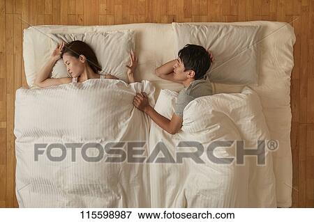 Stock Photo - Japanese couple in bed. Fotosearch