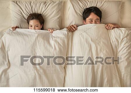 Stock Photo - Japanese couple in bed. Fotosearch