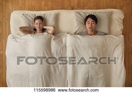 Stock Photograph - Japanese couple in bed. Fotosearch