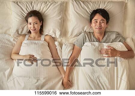 Stock Photograph - Japanese couple in bed. Fotosearch