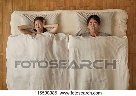 Stock Photography - Japanese couple in bed. Fotosearch