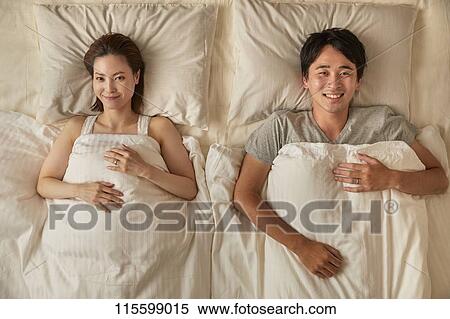 Stock Photography - Japanese couple in bed. Fotosearch
