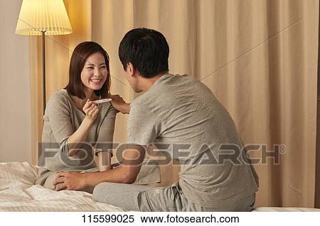 Stock Photography - Japanese couple in bed. Fotosearch