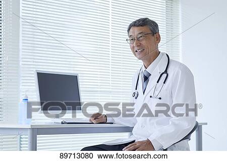 Stock Image - Japanese doctor at work. Fotosearch