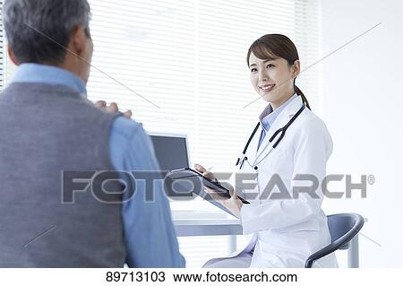 Stock Image - Japanese doctor at work. Fotosearch