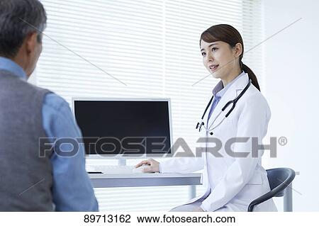 Stock Image - Japanese doctor at work. Fotosearch