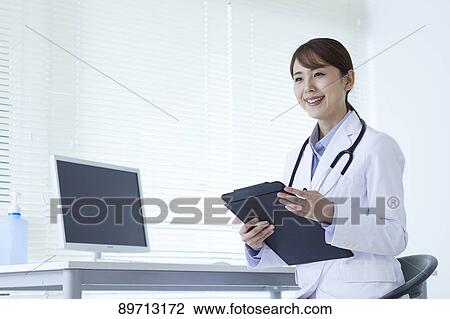 Stock Image - Japanese doctor at work. Fotosearch