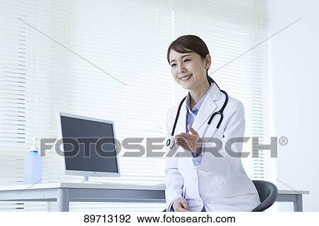 Stock Image - Japanese doctor at work. Fotosearch