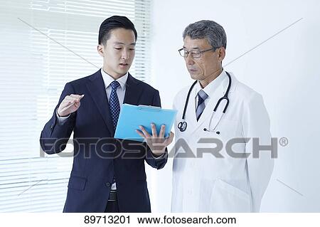 Japanese doctor at work View Large Photo Image Stock Image - Japanese doctor at work. Fotosearch