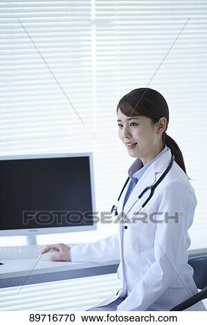 Stock Image - Japanese doctor at work. Fotosearch