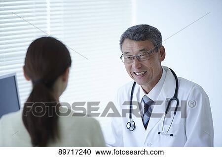 Stock Image - Japanese doctor at work. Fotosearch
