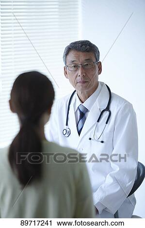 Stock Image - Japanese doctor at work. Fotosearch