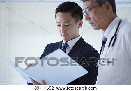 Stock Image - Japanese doctor at work. Fotosearch