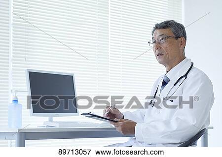 Stock Photo - Japanese doctor at work. Fotosearch