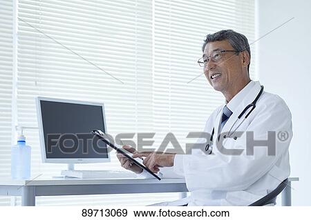 Japanese doctor at work View Large Photo Image Stock Photo - Japanese doctor at work. Fotosearch