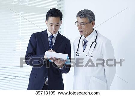 Japanese doctor at work View Large Photo Image Stock Photo - Japanese doctor at work. Fotosearch