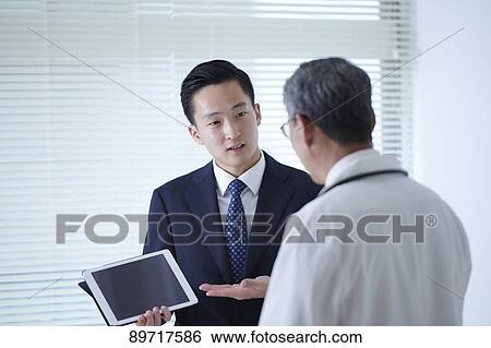Japanese doctor at work View Large Photo Image Stock Photograph - Japanese doctor at work. Fotosearch