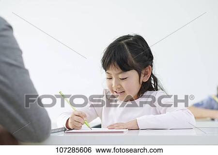 Stock Photograph - Japanese elementary school kid with teacher. Fotosearch