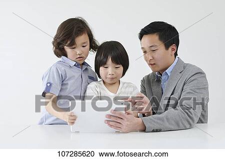 Stock Image - Japanese elementary school kids with teacher. Fotosearch