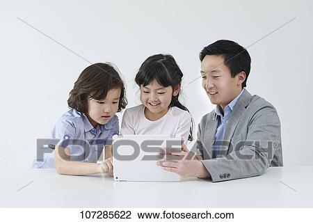 Stock Image - Japanese elementary school kids with teacher. Fotosearch