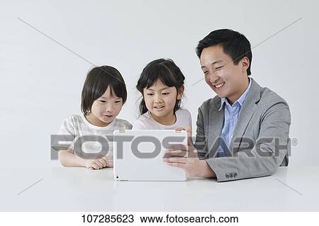 Stock Image - Japanese elementary school kids with teacher. Fotosearch