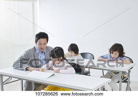 Stock Photograph - Japanese elementary school kids with teacher. Fotosearch