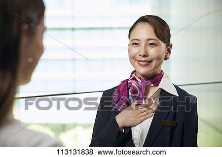 Japanese Flight Attendant helping customer View Large Photo Image Stock Photo - Japanese Flight Attendant helping customer. Fotosearch