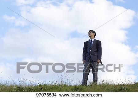 Picture - Japanese high school student in uniform outdoors. Fotosearch