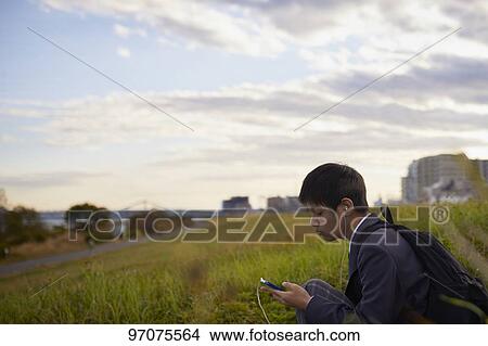 Picture - Japanese high school student in uniform outdoors. Fotosearch