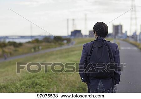 Stock Photo - Japanese high school student in uniform outdoors. Fotosearch