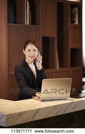 Stock Image - Japanese hotel concierge. Fotosearch